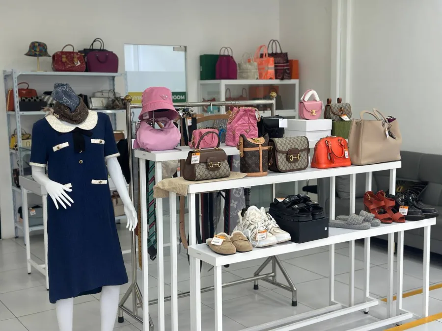 Curated clothing and accessory display with handbags, hats and shoes